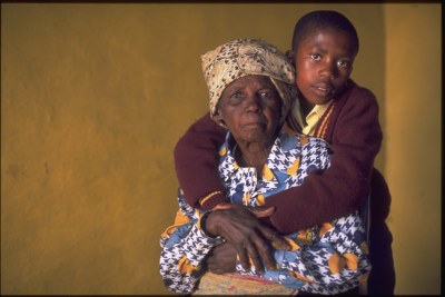 In Lesotho, a boy embraces his grandmother in their home in a village on the outskirts of Maseru.