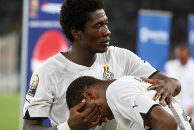 Ghana's Asamoah Gyan consoles teammate Dede Ayew after the Black Stars lost at a previous tournament.