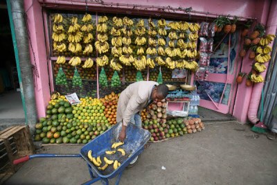 A fruit vendor preparing his stall in Merkato market, Addis Ababa.