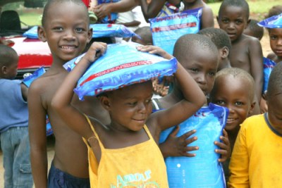 children carrying bed nets