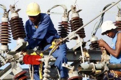 Kenya Power and Lighting Company Limited workers repair a power supply line.