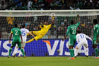 Vincent Enyeama of Nigeria saves a close range shot from Vasileios Torosidis of Greece