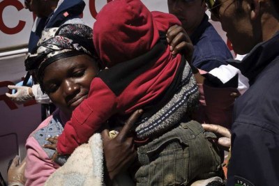 A mother and child rescued at sea when their boat sank in the Mediterranean (file photo).