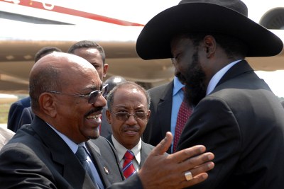 Omar Hassan Ahmad Al-Bashir (left), President of Sudan, and Salva Kiir Mayardit, President of the Republic of South Sudan, greet each other at the Independence Ceremony.