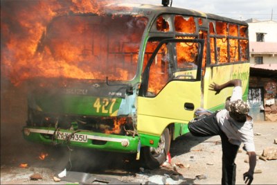 A man kicks a burning bus during demonstrations following the 2007 Kenyan elections (file photo).