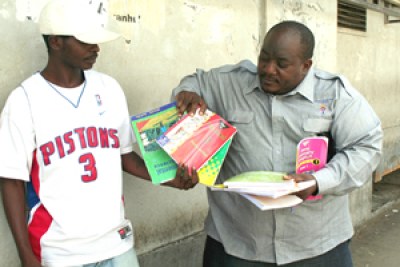 Raymond Majongwe takes books from vendors at Ximex Mall.