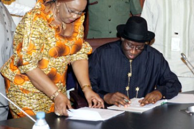 President Jonathan signs the 2012 Budget.