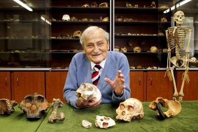 Professor Phillip Tobias with a collection of fossil hominid skulls from east and southern Africa at the University of the Witwatersrand in Johannesburg.
