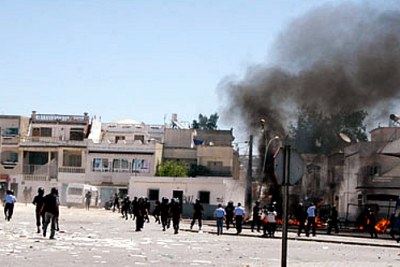 Clouds of black smoke hover over the heads of Tunisian security forces dispatched to the scene of violent protests, reportedly sparked by an art exhibition which 