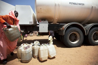 Distributing water (file photo): Fuel prices have gone up in the states of West and South Darfur, causing a transport crisis and scarcity of electricity and water.