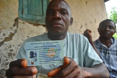 A Liberian refugee displays his ID card(file photo)
