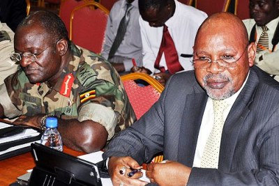 In Parliament: Minister of State for Defense Jeje Odongo (right) and Gen. Katumba Wamala demanded that the government explain its memorandum of understanding with the UN and the African Union over its mission in Somalia.