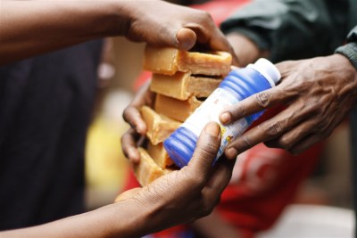 An aid worker distributes soap and bleach in Guinea's capital, Conakry, where people have been infected with cholera.