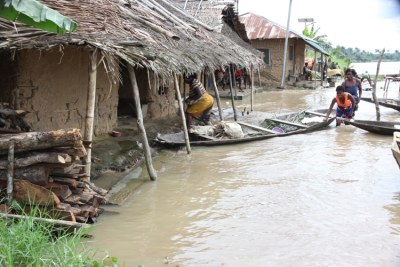 Women with a dug-out canoe in front of their flooded homes in Toru-Orua in Bayelsa state, Nigeria after the worst floods in 35 years.