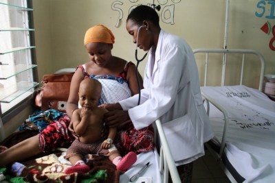 An eight-month-old boy with pneumonia is examined by a doctor (file photo).