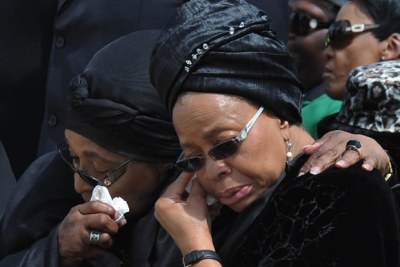 Graca Machel and Winnie Madikizela-Mandela at the arrival of the remains of former South African president Nelson Mandela at Mthatha Airport in the Eastern Cape.