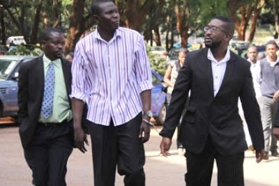 Dj Munya walks handcuffed to one of his alleged accomplices Mohammed Matare while flanked by two detectives.