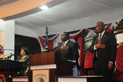 President Ellen Johnson Sirleaf, House Speaker Alex Tyler and Vice President Joseph Boakai stand as the National Anthem is played.