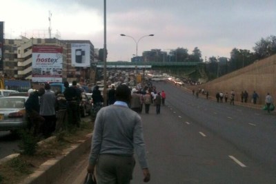 Nairobi residents walk to work as transport is paralysed following protests over increased parking fee.