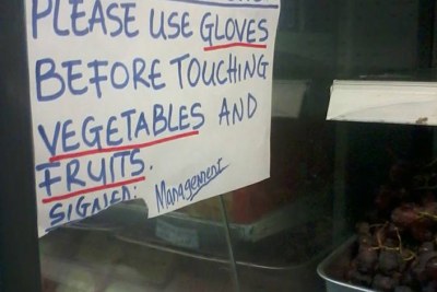 A sign at the fruit section of a grocery store urging customers to wear gloves, as Liberians worry about the spread of the deadly Ebola virus.