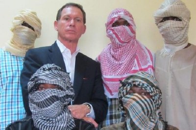 Stephen Davis, with some masked 'Boko Haram members' (file photo).