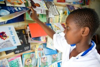 A Tanzanian boy peruses books in a Dar es Salaam bookshop.