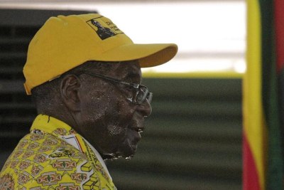 President Robert Mugabe seen here sweating as he leaves the stage after delivering a speech at a Zanu-PF congress.