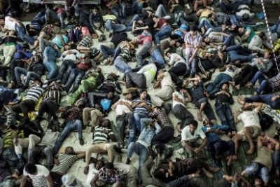 Rescued migrants sleep after being plucked from a boat off the coast of Italy in summer 2014. Most boat arrivals in 2014 were asylum seekers from Syria, Eritrea and elsewhere.