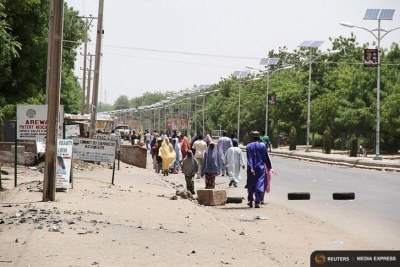 People walk along a road as they flee, in Maiduguri in Borno State (file photo).