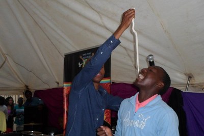 A pastor feeds a snake to one of the congregants: Mkhwanazi-Xaluva has said some of the pastors under investigation have described her as a devil worshipper to their followers (file photo).