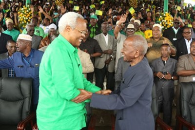 Monduli MP Edward Lowassa greets veteran politician Kingunge Ngombale-Mwiru (right) at Sheikh Amri Abeid (file photo).
