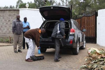 Police officers in front of Pastor James Ng'ang'a's residence following a break in a night after the pastor was charged with causing a fatal road accident and conspiracy.