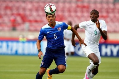 Nigeria player fights for a ball against U.S.A.