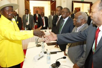 President Yoweri Museveni, left, greets former Burundian presidents Jean Baptiste Bagaza, right, Domitien Ndayizeye, second right, Sylvestre Ntibantunganya, and Pierre Buyoya at Entebbe State House, Uganda on December 28, 2015. The four are part of the mediation team aimed at ending months of violence in Burundi.