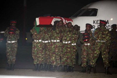 Soldiers at Wilson Airport carry the four bodies soon after being offloaded from a Kenya Air Force plane on January 18, 2016.