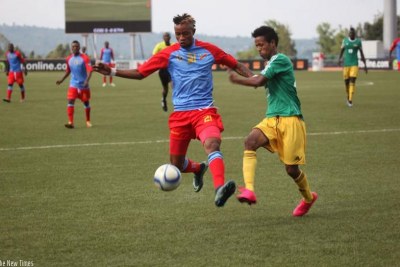 Congo's Jonathan Bolingi Mpangi battles with Ethiopia's Tekalign De Jene at Huye Stadium.