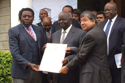 Former President Mwai Kibaki (centre) receives his certificate of appointment as a special envoy for water in Africa from Unesco Regional Director Mohammed Djelid (right) and Water Cabinet Secretary Eugene Wamalwa in Nairobi.