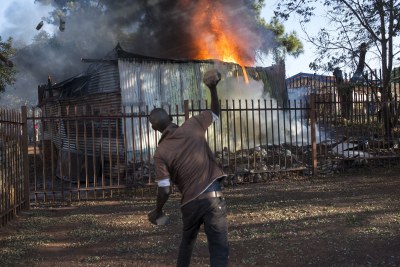 A shack on fire during protests in Tshwane.