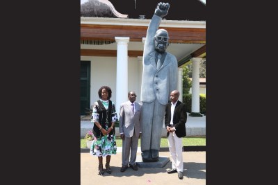 Sculptor Dominic Benhura, far right, has been forced to explain his style after criticism over his President Mugabe's statue.
