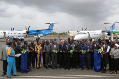 President John Magufuli cuts a ribbon to inaugurates the newly purchased two aircraft at Julius Nyerere International Airport .