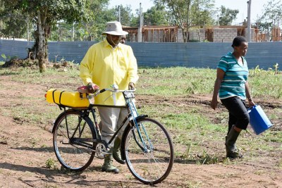 Museveni going to fetch water for irrigation.