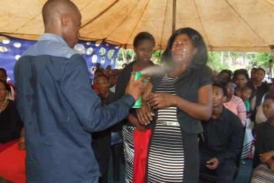Prophet Lethebo Rabalago sprays Doom at a member of his congregation (file photo).