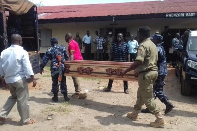 Sad send off. Police officers load coffins containing the bodies of their colleagues onto a truck to be transported to different destinations.