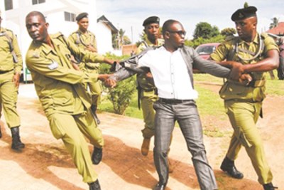 Police officers arresting Kilombero Member of Parliament Peter Lijualikali.