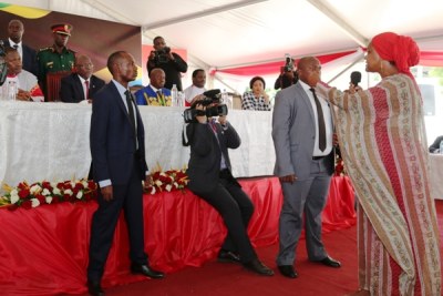 President John Magufuli attentively listens to Tanga-based resident, Shosi, as she was expressing her grievances regarding inheritance from her late husband at an official function to mark the Law Day in Dar es Salaam.