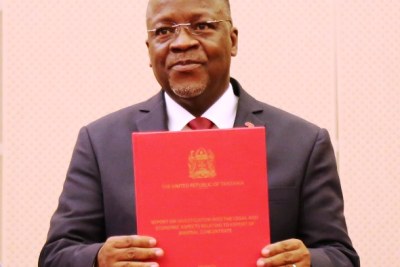President John Magufuli displays the second report on mineral sand investigation shorlty after receiving it from the special committee he assigned to undertake the task, at the State House in Dar es Salaam.