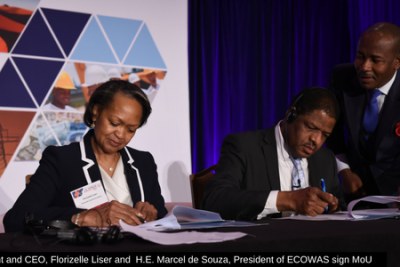 CCA president and CEO, Florizelle Liser and H.E. Marcel de Souza, President of ECOWAS sign a MoU