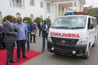 President Uhuru Kenyatta, right, handing out ambulances (file photo).