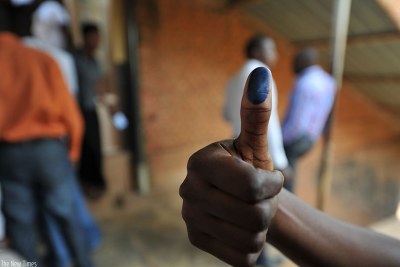 Un électeur ayant déjà voté montre son doigt émasculé d'encre indélébile.