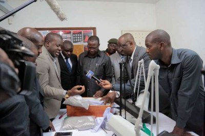 Finance and Planning Minister, Dr Philip Mpango, centre, gets clarification on diamonds impounded at the Julius Nyerere International Airport  on August 31. Looking on are: Prof Abdulkarim Mruma, 2nd right, Tanzania Revenue Authority Commissioner General Mr Charles Kichere, partly obscured - 3rd right, Deputy Director General of the Prevention and Combatting of Corruption Bureau Brigadier General John Mbungo, 4th right, and the Director of Public Prosecutions Biswalo Mganga (immediate right to the Minister).